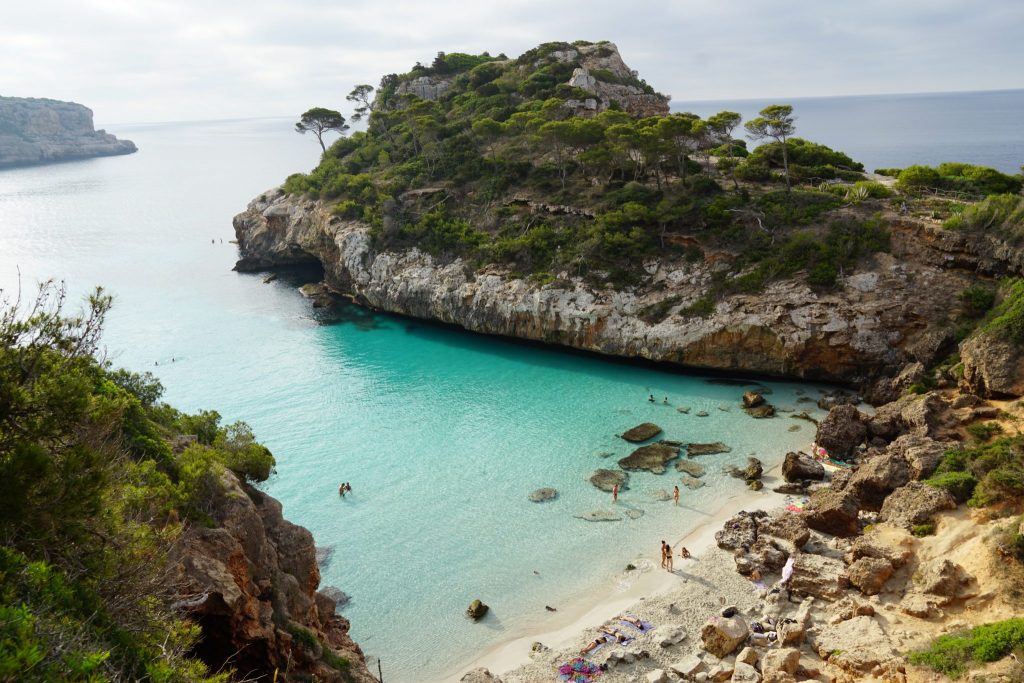 Crystal-clear water and cliffs at Caló des Moro beach in Mallorca

