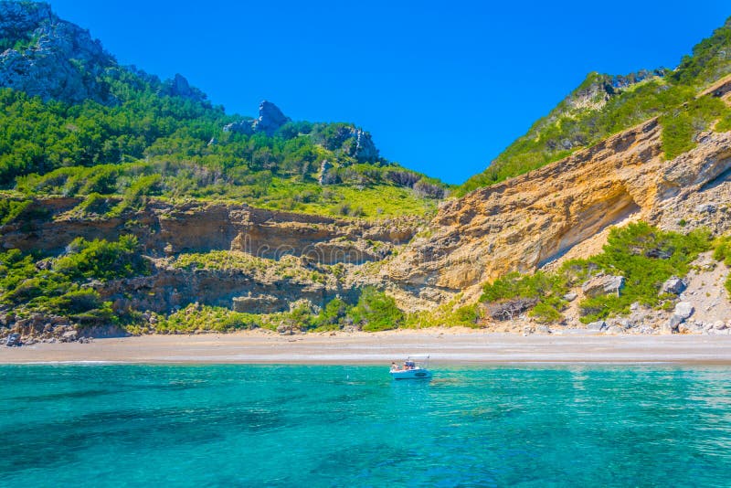 Remote black-pebble shoreline at Platja des Coll Baix

